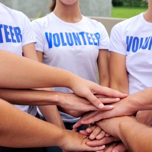 volunteer group hands together