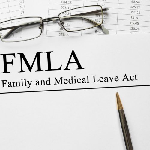 Paper with Family Medical Leave Act FMLA on a table